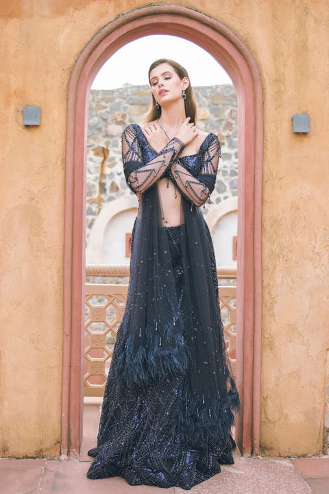 A navy embellished set with a structured blouse, sheer sleeves, and a beaded skirt. Unbreakable is crafted for t