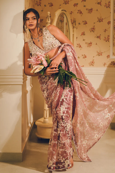 A blush pink hand-embroidered saree with shimmering sequins and delicate floral motifs. Perfect for weddings and evening soirées.