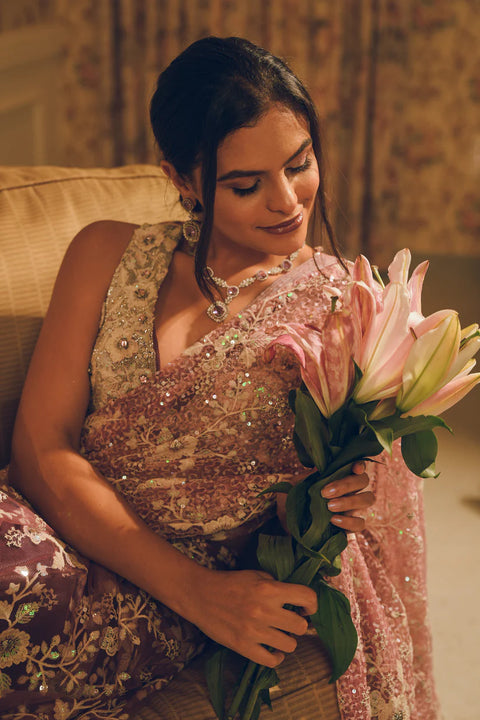 A blush pink hand-embroidered saree with shimmering sequins and delicate floral motifs. Perfect for weddings and evening soirées.