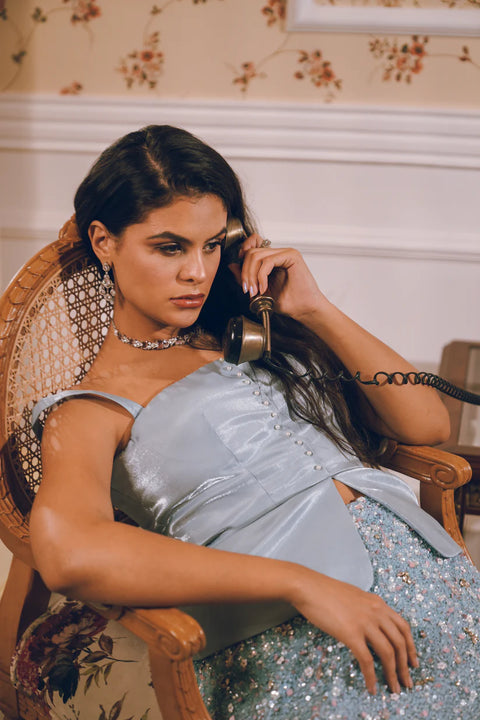 A pastel blue embellished skirt paired with a structured satin top, blending modern chic with couture detailing. Designed for women who love effortless mix-and-match glamour. Perfect for engagement parties, wedding festivities, and festive soirées.