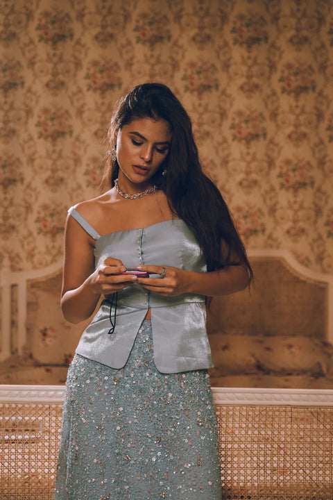 A pastel blue embellished skirt paired with a structured satin top, blending modern chic with couture detailing. Designed for women who love effortless mix-and-match glamour. Perfect for engagement parties, wedding festivities, and festive soirées.