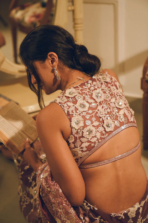 A blush pink hand-embroidered saree with shimmering sequins and delicate floral motifs. Perfect for weddings and evening soirées.